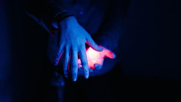hands glowing in the dark