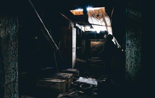 man looking up from a trap door