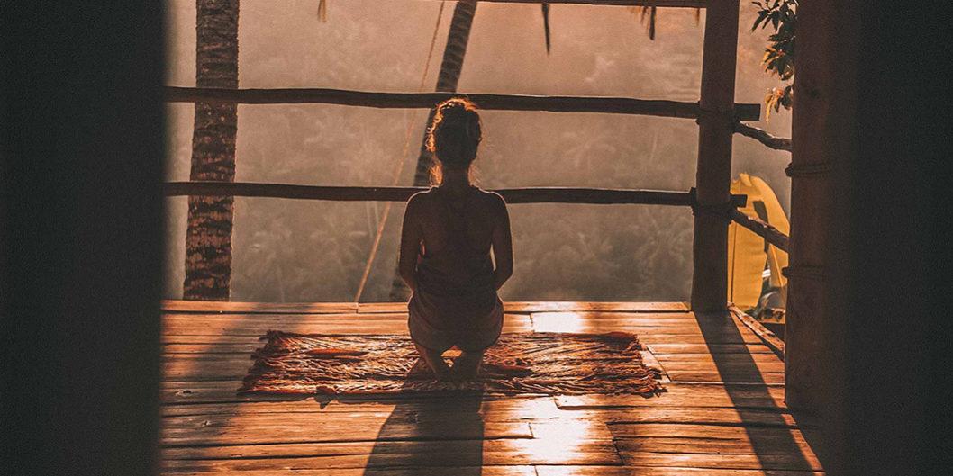 girl looking out window in meditation