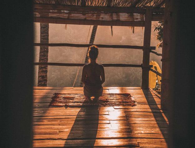 girl looking out window in meditation