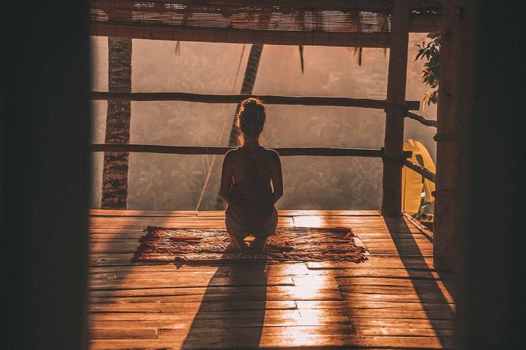 girl looking out window in meditation