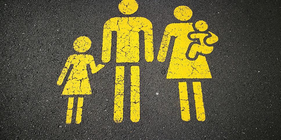 yellow concrete road sign of family