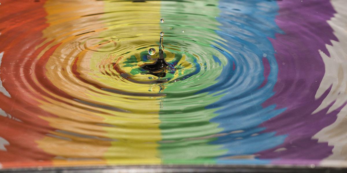 water puddle showing LGBT colors
